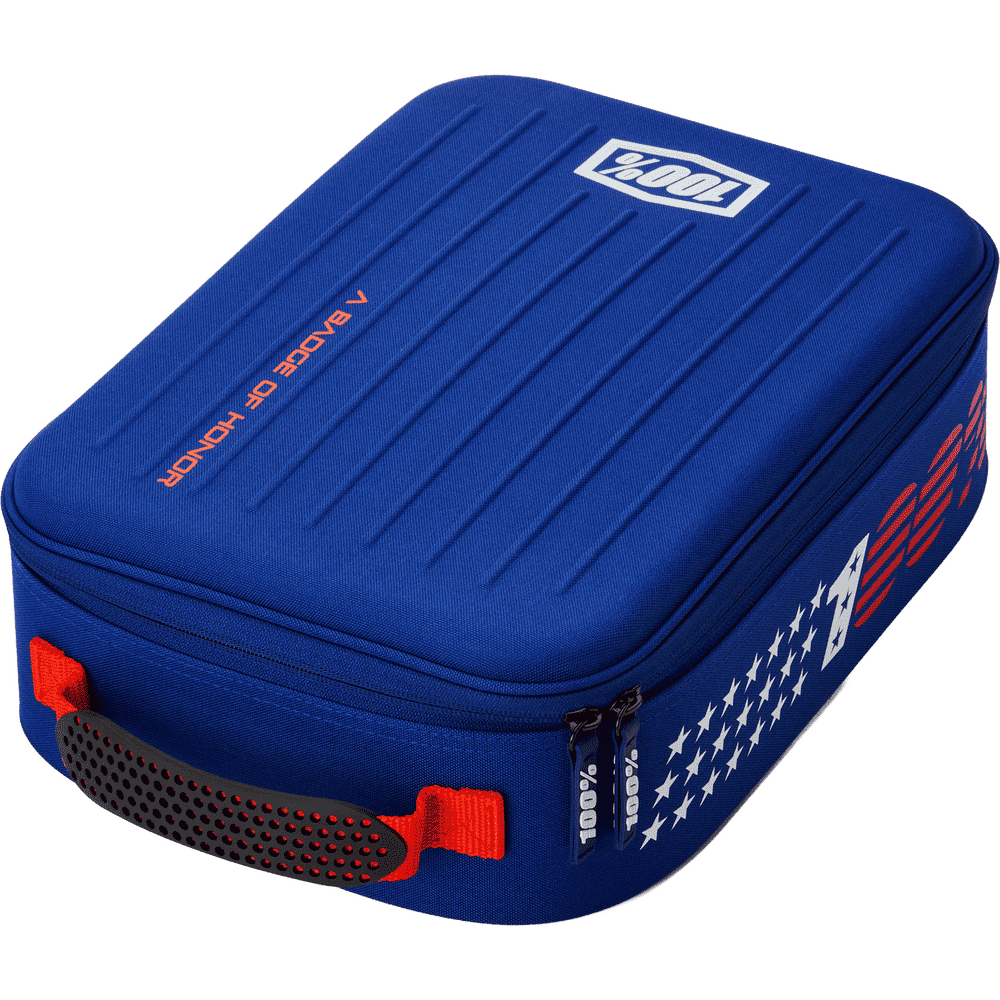 100% blue motorcycle goggle carrying case with red and white patriotic graphics, featuring a textured lid, side zipper, and red handle on a white background.