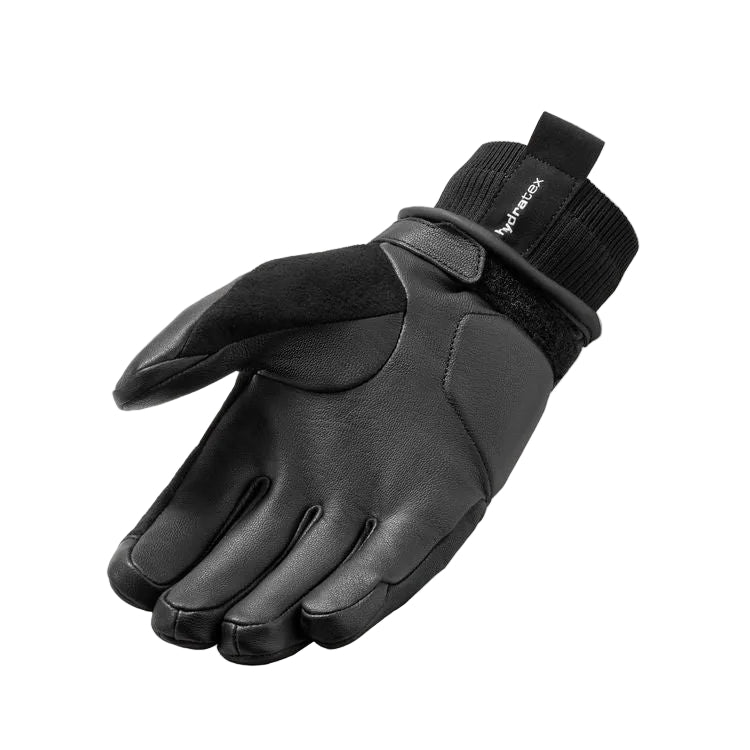 A single black winter glove with a knit cuff and hook-and-loop strap closure, shown on a plain white background. The brand name 'Mipracex' is visible on the cuff.