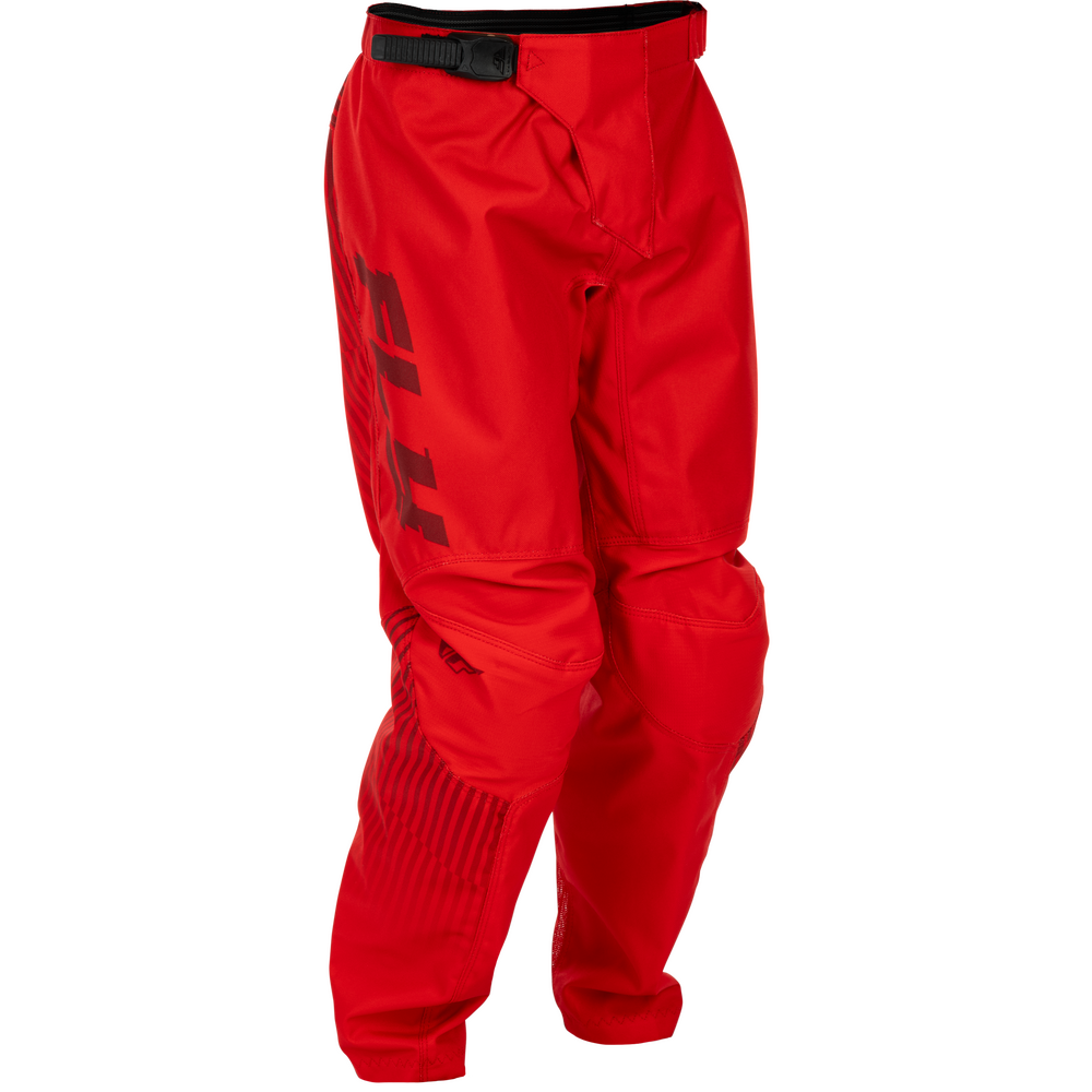 Red motocross pants with a black waistband and a large black Fox logo printed vertically on the left leg, shown against a plain white background.
