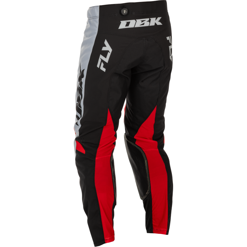 Black, red, and gray motocross pants with white branding, shown on a clean white background.