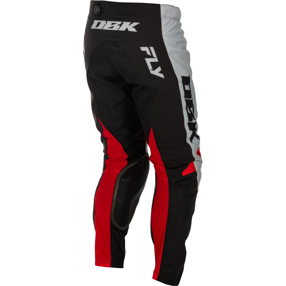 Black, red, and gray motocross pants with white and black DBK branding, shown from a three-quarters back angle on a white background.