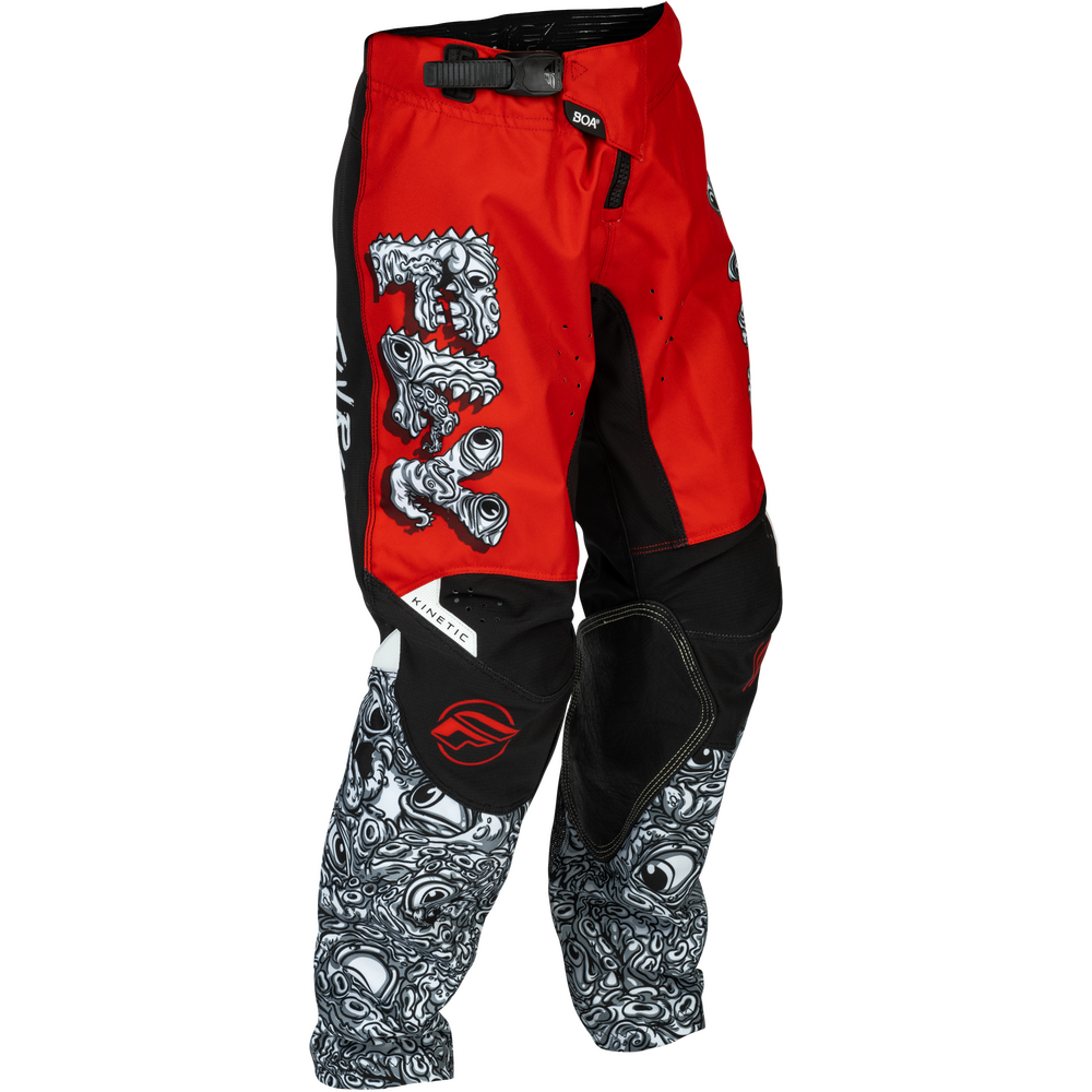 Red and black motocross pants with a large white and black skull graphic on the thigh and a matching skull pattern down the lower legs, shown on a white background.