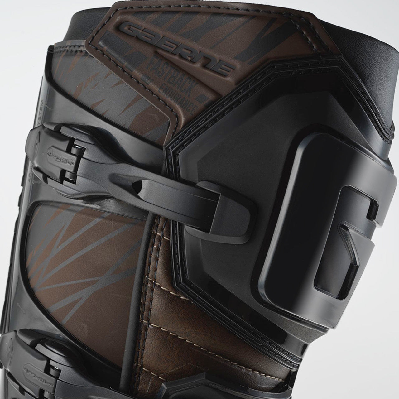 Close-up of a black and brown protective knee pad with branding on a light gray background