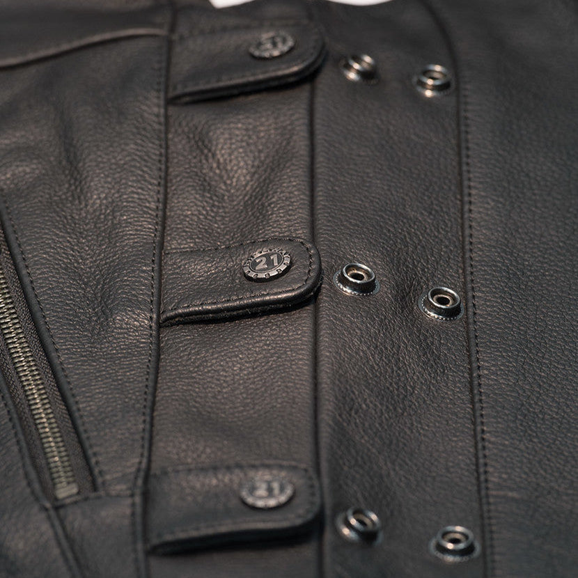 Close-up of a black leather jacket with buttons and zippers.