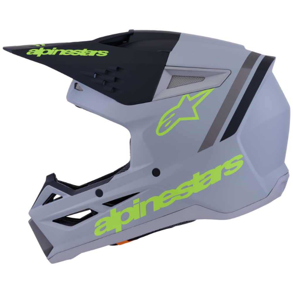 Gray motocross helmet with green Alpinestars branding on a white background
