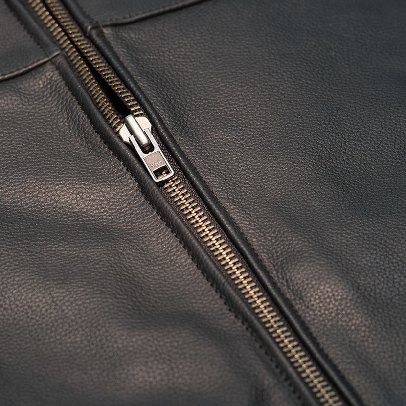 Close-up of a black leather jacket with a zipper