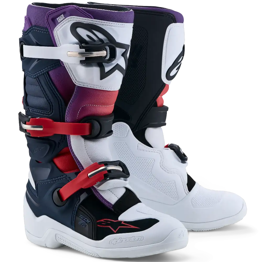 A pair of dark blue, white, and black motocross boots on a white background