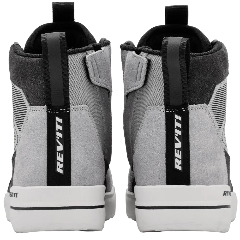 Gray high-top sneakers with black straps and 'REV'IT!' branding on a white background