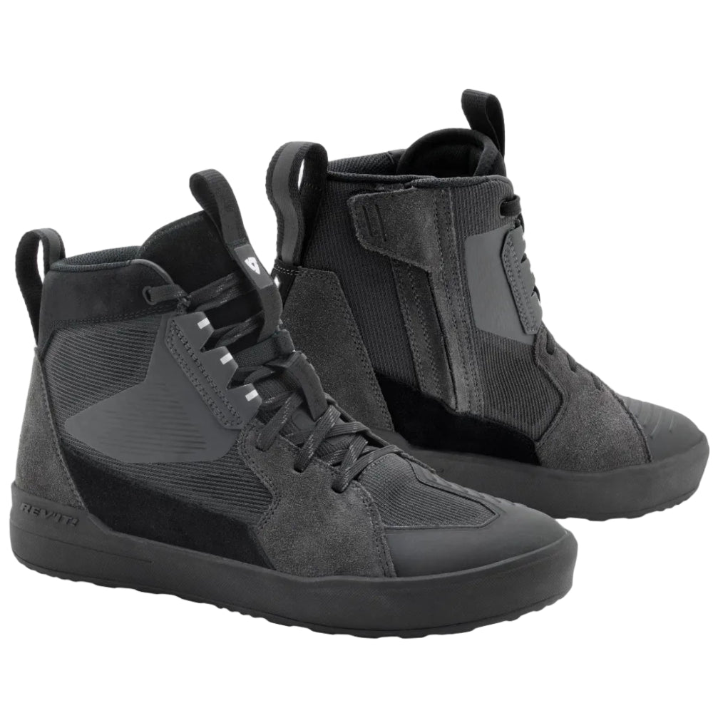 Pair of black high-top Motorcycle riding sneakers on a light gray background