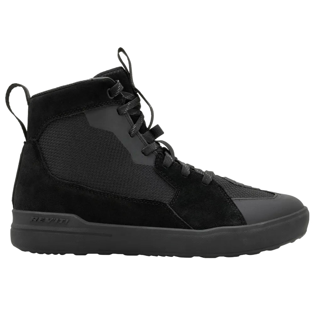Black Chelsea boot on a light gray background