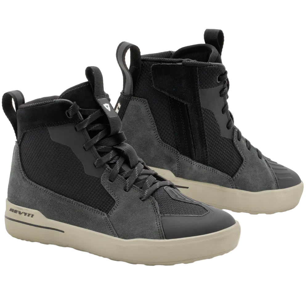 A pair of high-top sneakers in dark gray and black suede and mesh, featuring off-white soles, displayed on a light beige background.