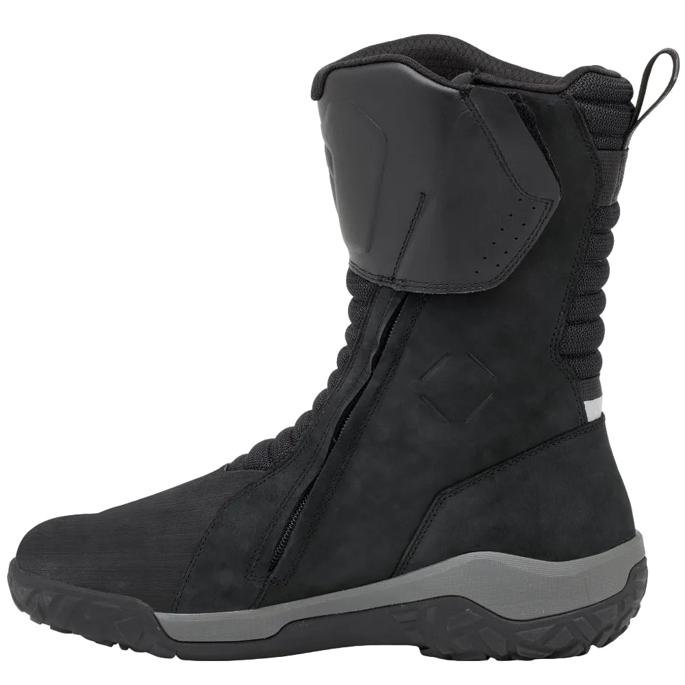 A black mid-calf tactical boot with a gray sole, shown in a side profile view against a light beige background.