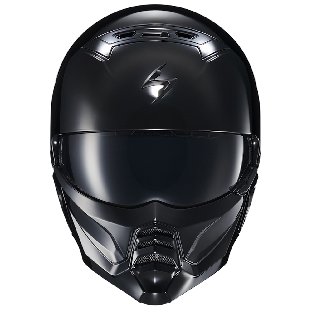 A matte black full-face motorcycle helmet with a dark visor and a stylized silver logo on the forehead, shown against a plain white background.