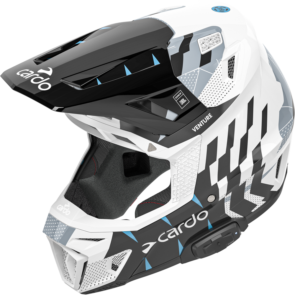 An off-road motorcycle helmet by Cardo, featuring a white, black, and gray geometric pattern with light blue accents, shown from a three-quarters angle on a white background.