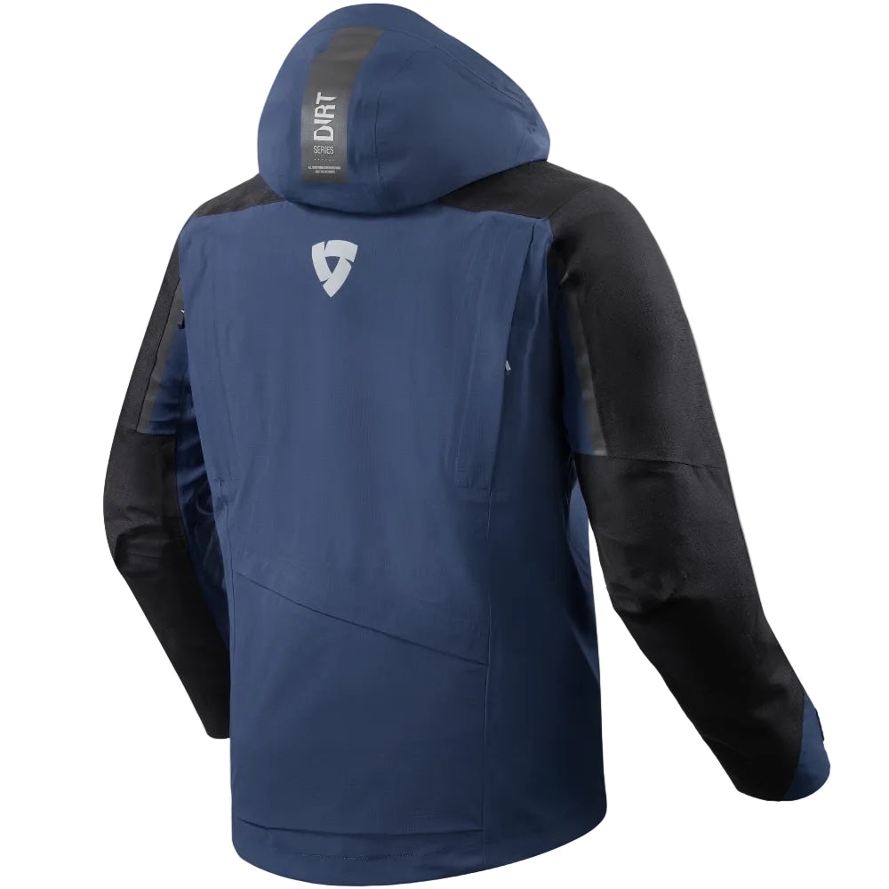 A navy blue and black hooded jacket shown from the back, featuring a white shield logo on the upper back and a vertical 'DIRT' label on the inside of the hood, set against a light beige background.