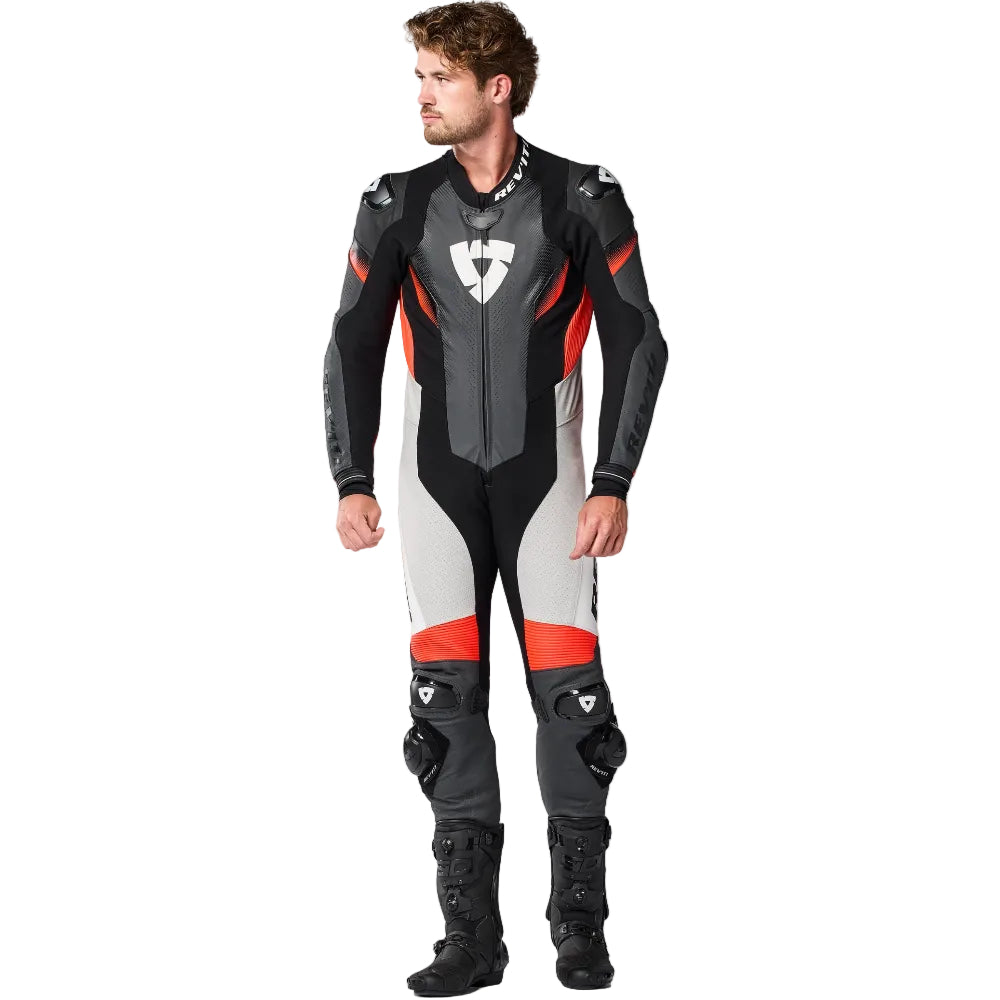 Person wearing a black, gray, and red motorcycle suit on a white background