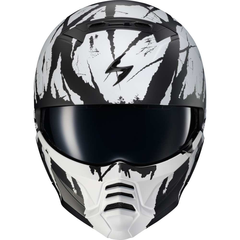 A full-face motorcycle helmet with a black and white graphic design, featuring a dark visor and a stylized lightning bolt logo on the forehead.
