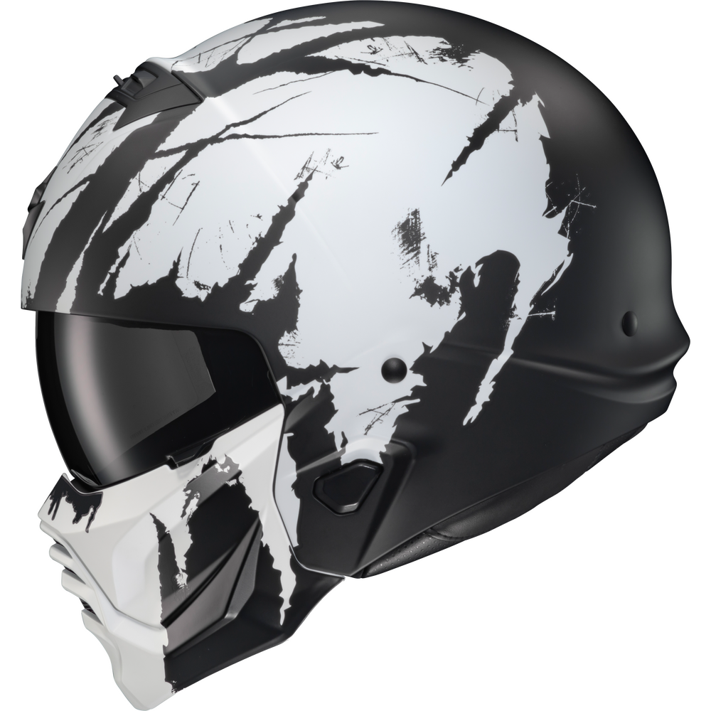 A full-face motorcycle helmet with a matte black and white abstract splatter design, featuring a dark visor and a matching white chin guard, shown against a plain white background.