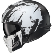 A full-face motorcycle helmet with a matte black and white abstract splatter design, featuring a dark visor and a matching white chin guard, shown against a plain white background.