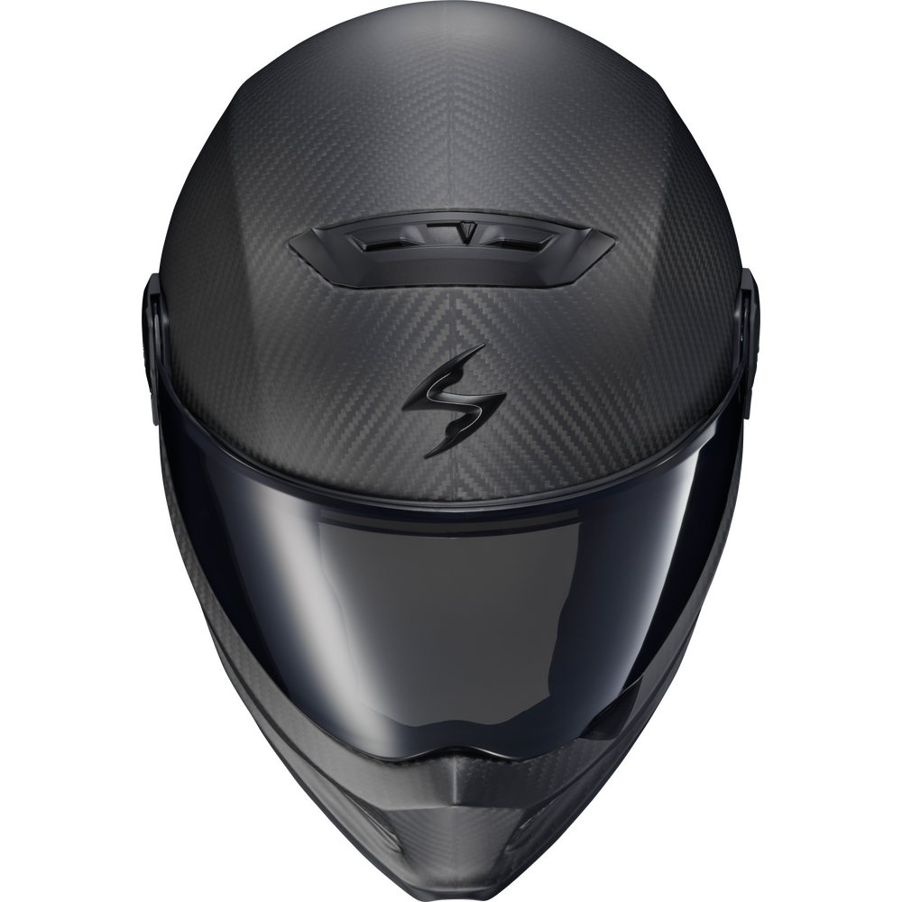 A full-face motorcycle helmet in a dark matte carbon fiber finish with a dark visor, featuring a stylized 'S' logo on the forehead, shown against a plain white background.