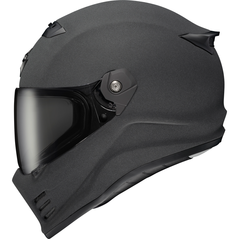 A matte black full-face motorcycle helmet with an integrated dark visor, shown in a clean side profile on a solid white background.