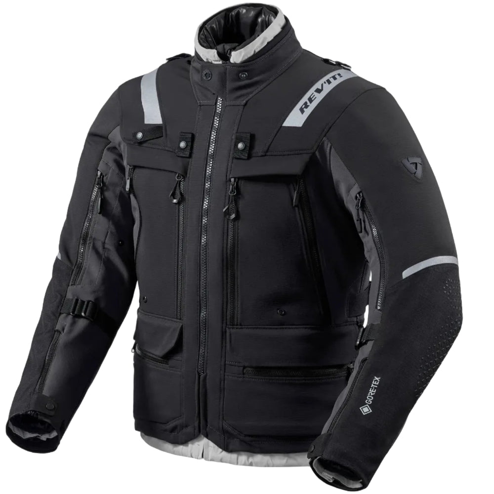 A black and gray Revit motorcycle jacket with reflective gray stripes, multiple zippered pockets, and a high collar, shown on a plain white background.