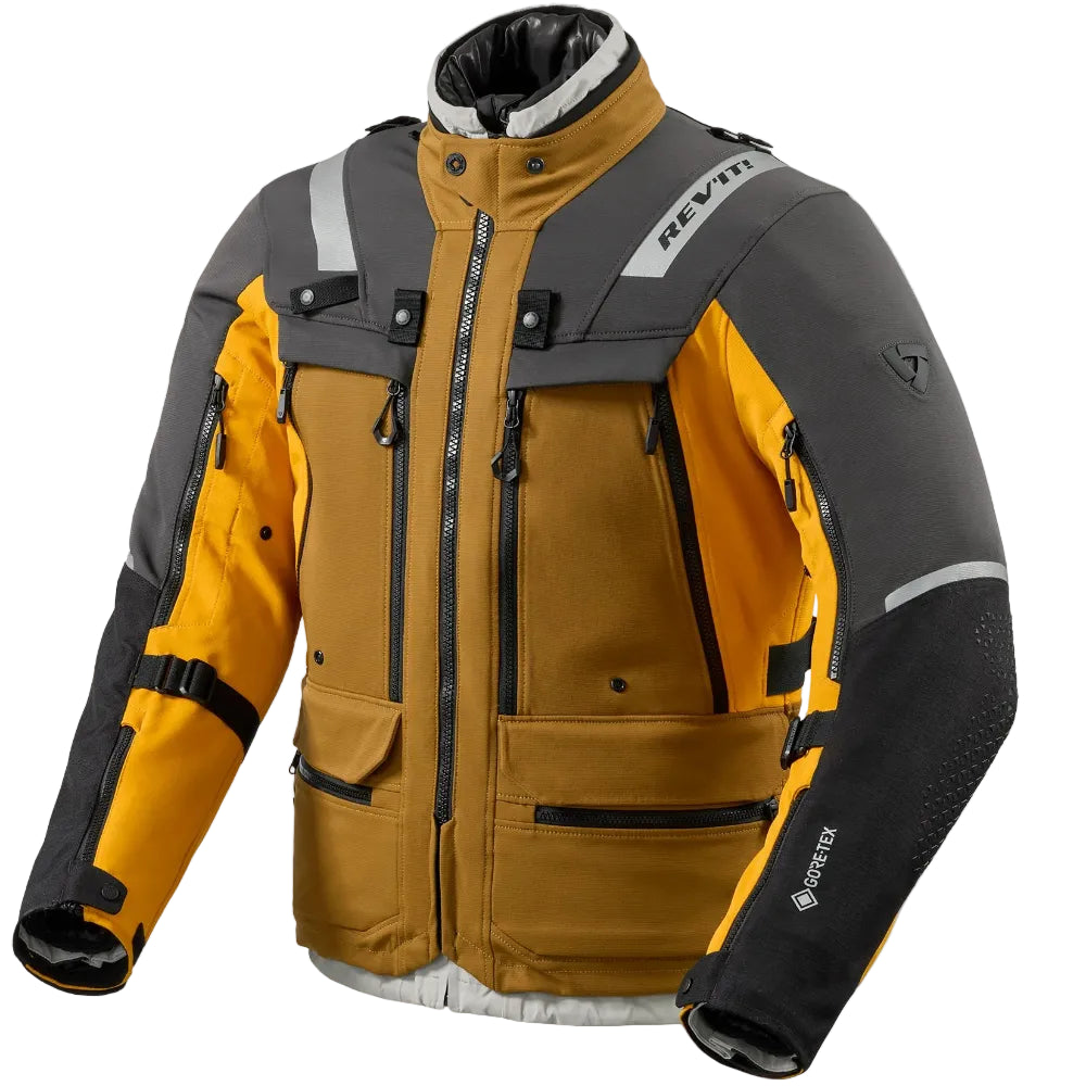 A technical motorcycle jacket in a color-blocked design of mustard yellow, dark gray, and black, featuring reflective stripes and multiple zippered pockets, shown against a light gray background.