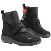 Black motorcycle boots with strap details on a white background