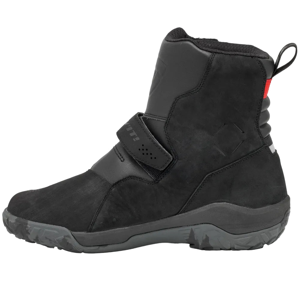 Black high-top sneaker with a strap on a light gray background