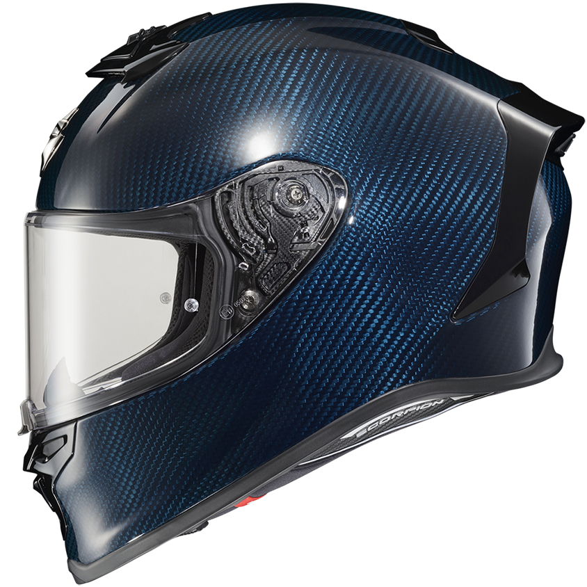 A full-face motorcycle helmet featuring a glossy dark blue carbon fiber weave pattern, a clear visor, and black trim details, shown against a plain white background.