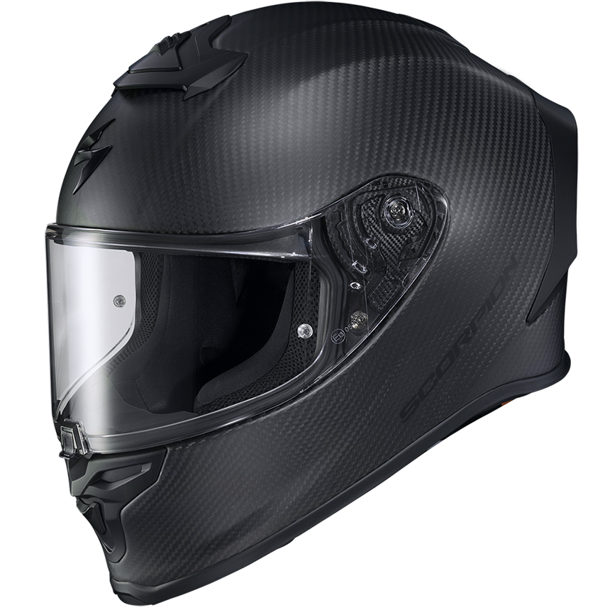A full-face motorcycle helmet with a black carbon fiber pattern, a clear visor, and a dark interior, shown from a three-quarters angle on a white background.