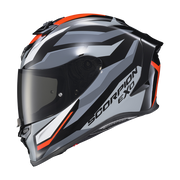 A full-face motorcycle helmet in a metallic gray, black, and white color scheme with bright orange accents and a dark visor. The brand name 'SCORPION EXO' is printed on the side.