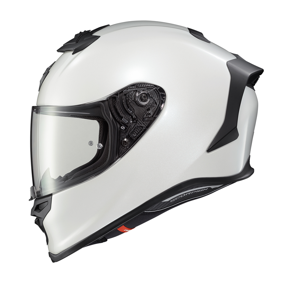 A white full-face motorcycle helmet with a clear visor and black trim details, shown from a side profile on a white background.