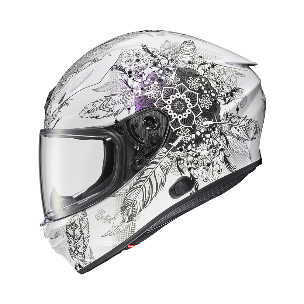 A full-face motorcycle helmet with a white base and an intricate black and gray graphic print featuring skulls, feathers, and floral mandala patterns. The helmet is shown with a clear visor against a plain white background.