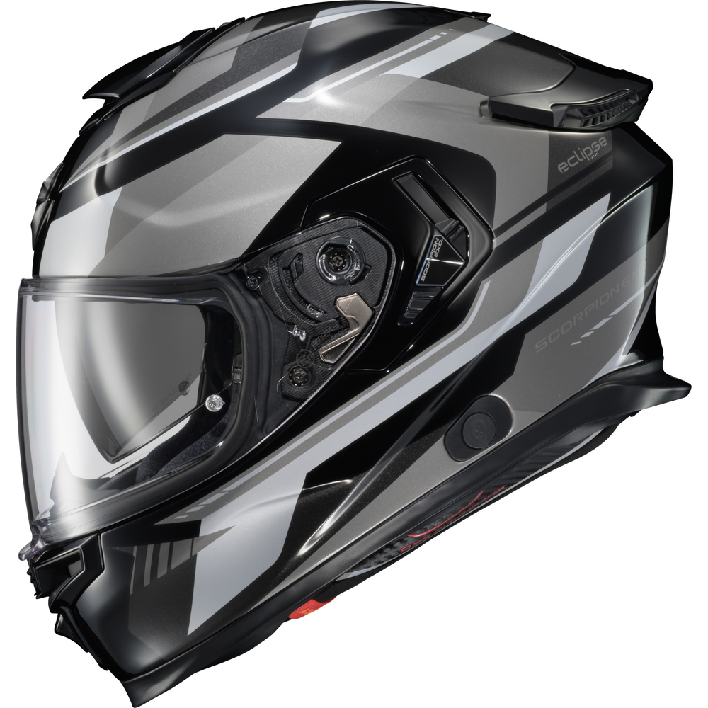 A full-face motorcycle helmet in a glossy black and metallic silver color scheme, featuring a clear visor and visible electronic components on the side, set against a plain white background.