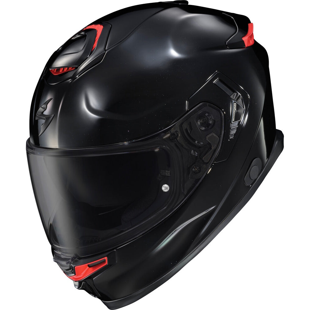 A glossy black full-face motorcycle helmet with small red accents on the top and lower chin area, shown against a plain white background.