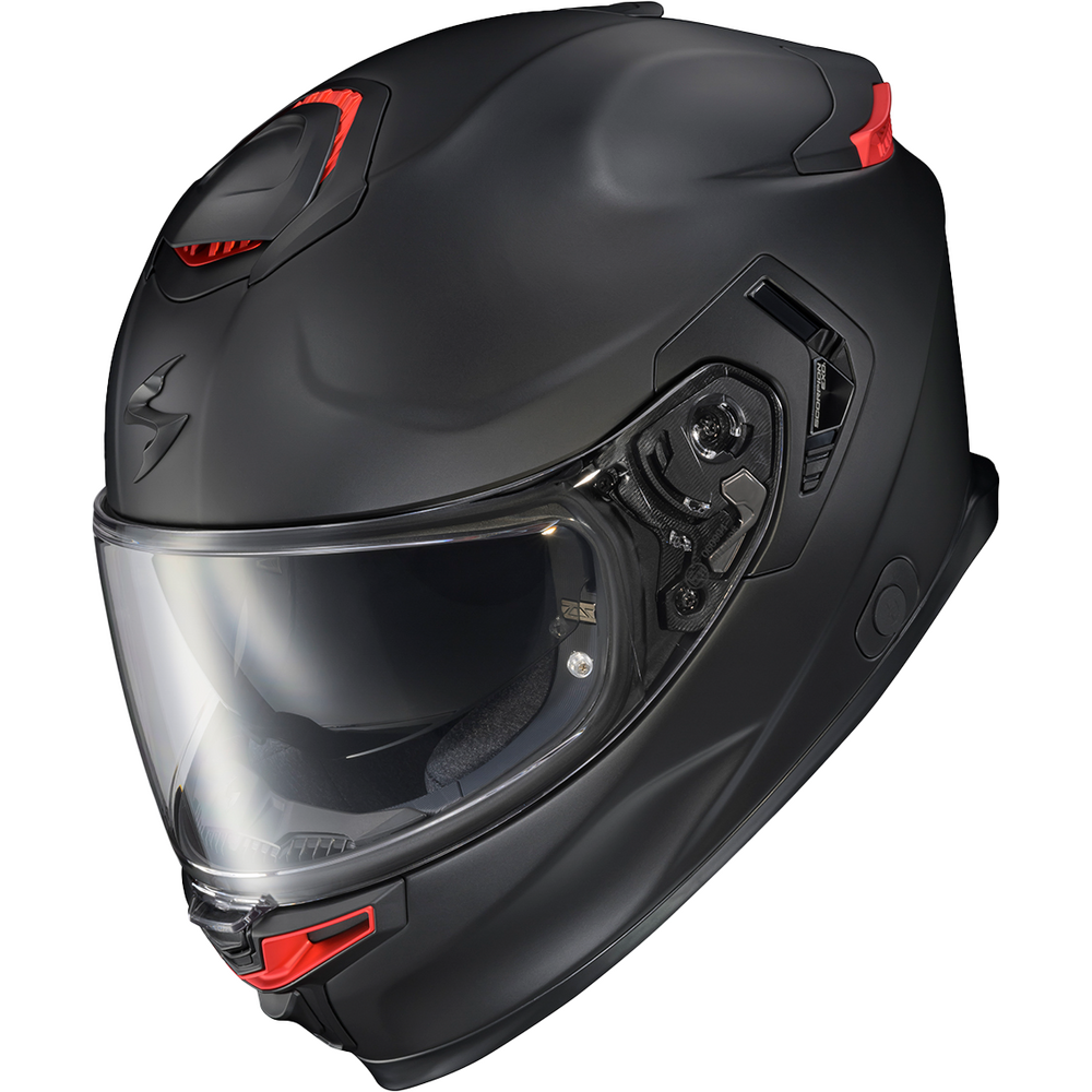 A matte black full-face motorcycle helmet with small red accents on the top and chin area, featuring a clear visor, shown on a plain white background.