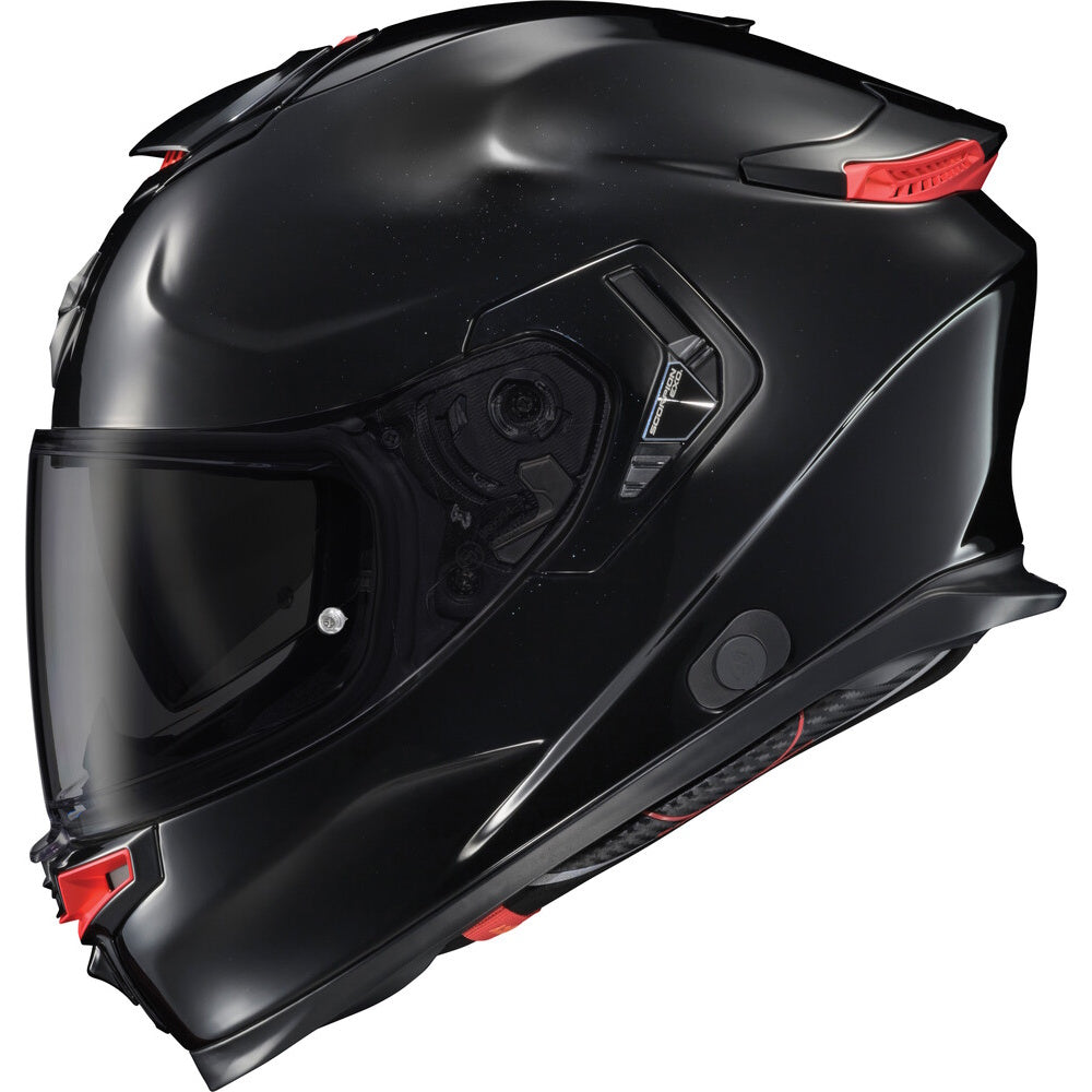 A matte black full-face motorcycle helmet with a dark tinted visor and small red accents on the side and top, shown against a plain white background.