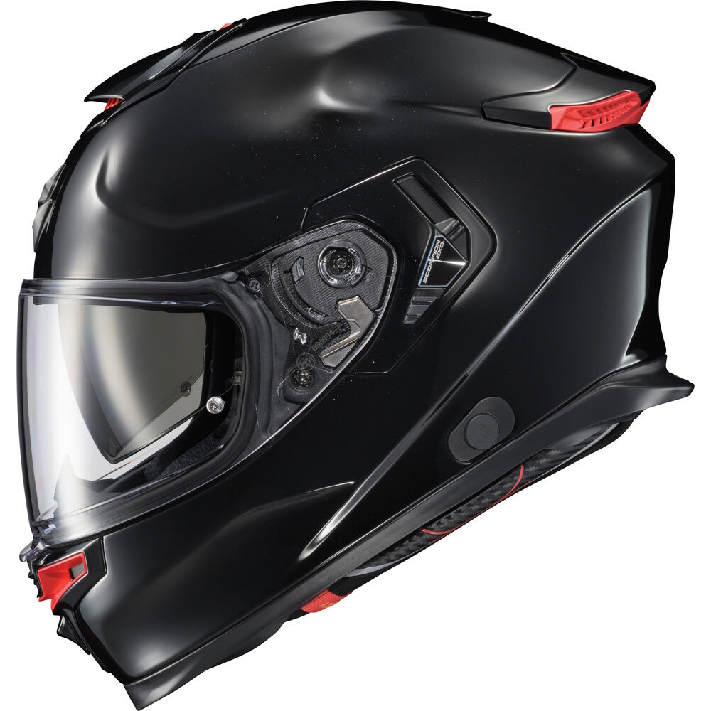 A matte black full-face motorcycle helmet with a clear visor and small red accents, shown from a three-quarters angle on a white background.