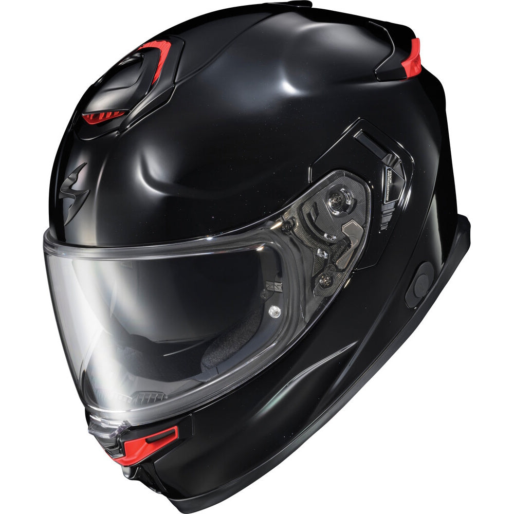 A glossy black full-face motorcycle helmet with a clear visor and small red accents, shown on a plain white background.