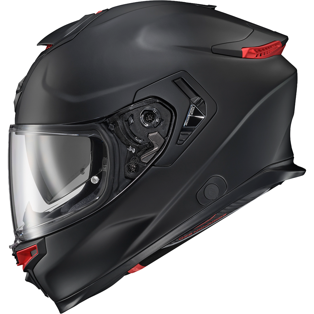 A matte black full-face motorcycle helmet with a clear visor and small red accents, shown on a plain white background.