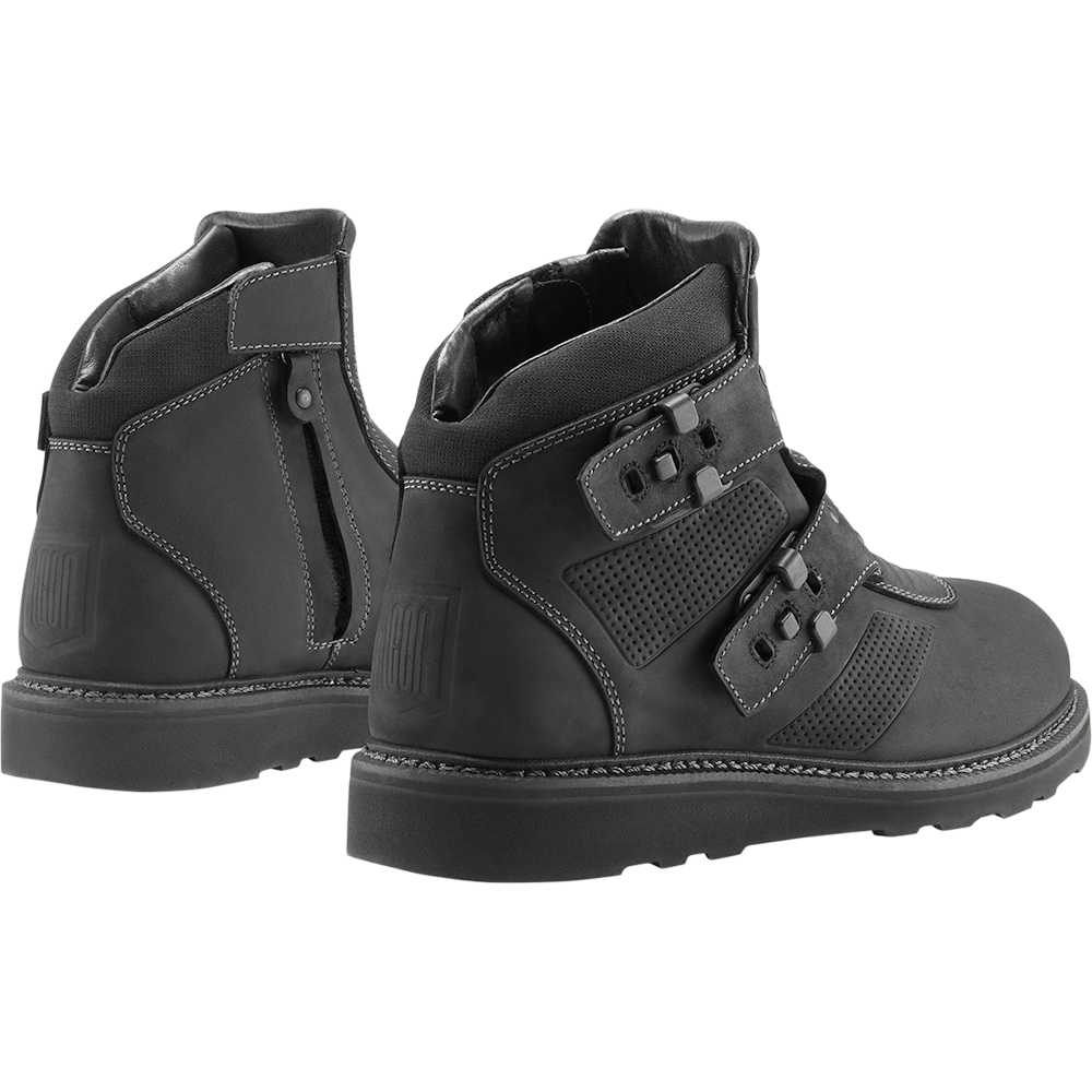 Black leather boots with visible stitching on a white background
