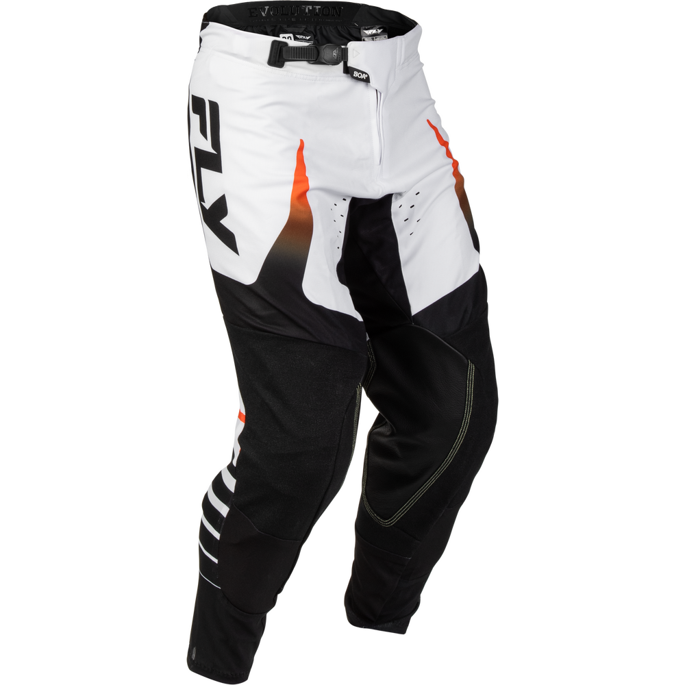 White and black motocross pants with orange flame accents and a large black Fly logo on the side, shown on a white background.