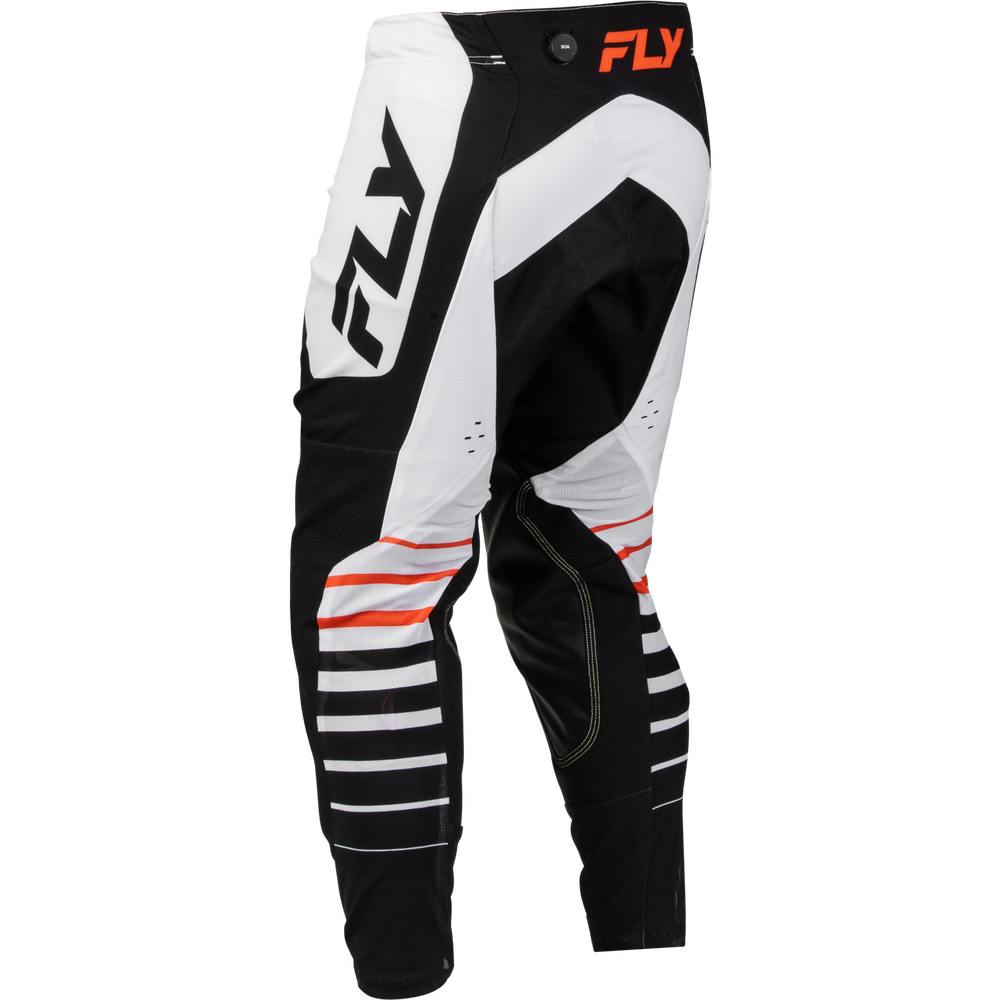 Black and white motocross pants with orange and black FLY branding, shown on a clean white background.