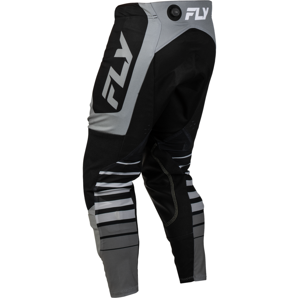 Black and gray motocross pants with white FLY logos on the upper thigh and waistband, shown from a three-quarters angle on a white background.