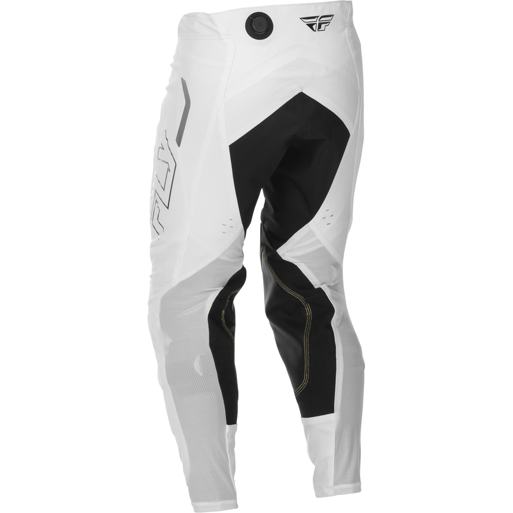 White motocross pants with black panels and gray graphic details, featuring a black dial closure at the waist and a small wing logo on the upper right thigh.