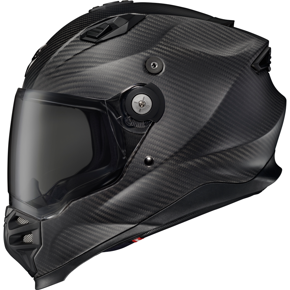 A full-face motorcycle helmet with a glossy black carbon fiber pattern, featuring a dark visor and visible ventilation valves and adjustment screws.