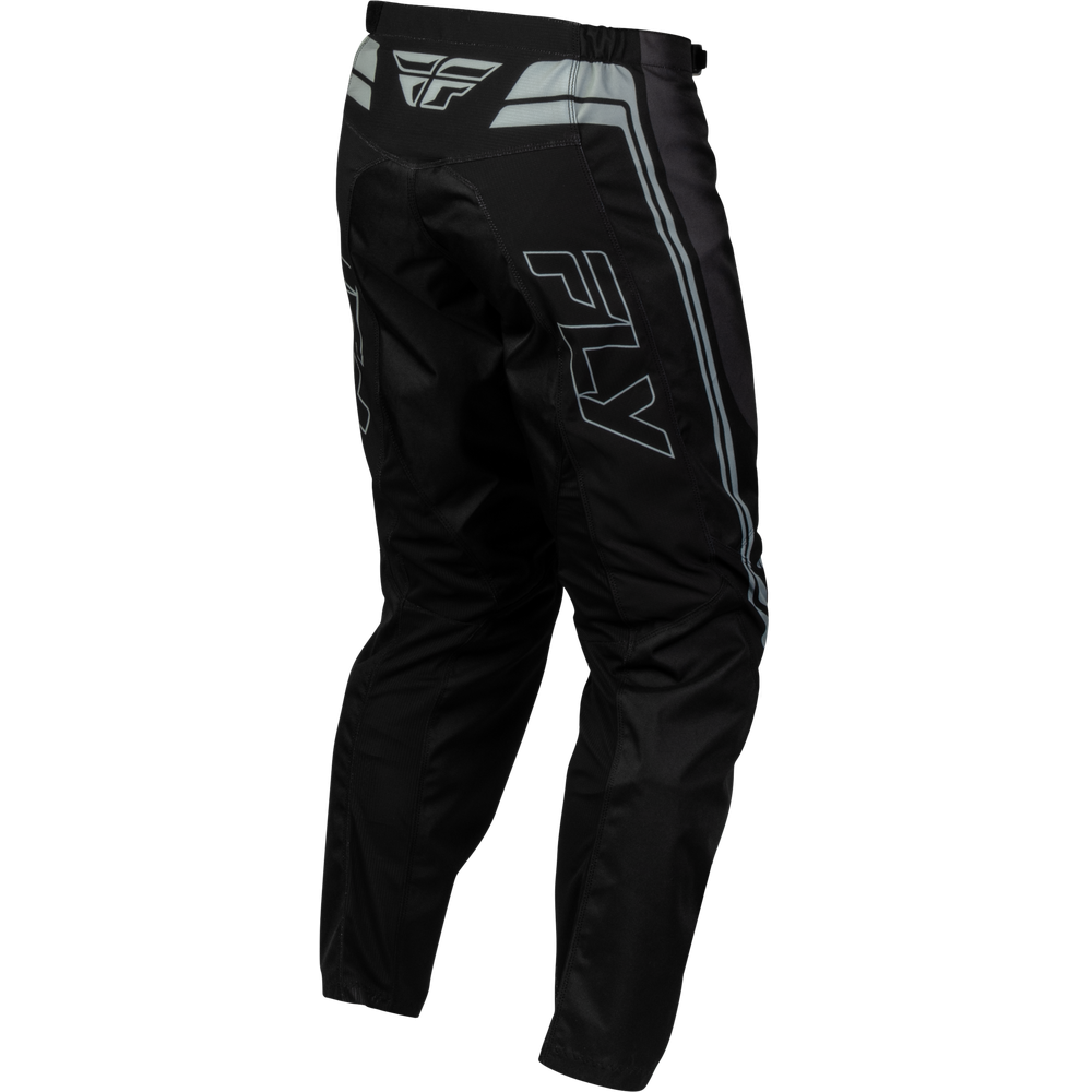 Black motocross pants with gray and white reflective stripe details and a large gray outlined 'FLY' logo on the left leg, shown on a plain white background.