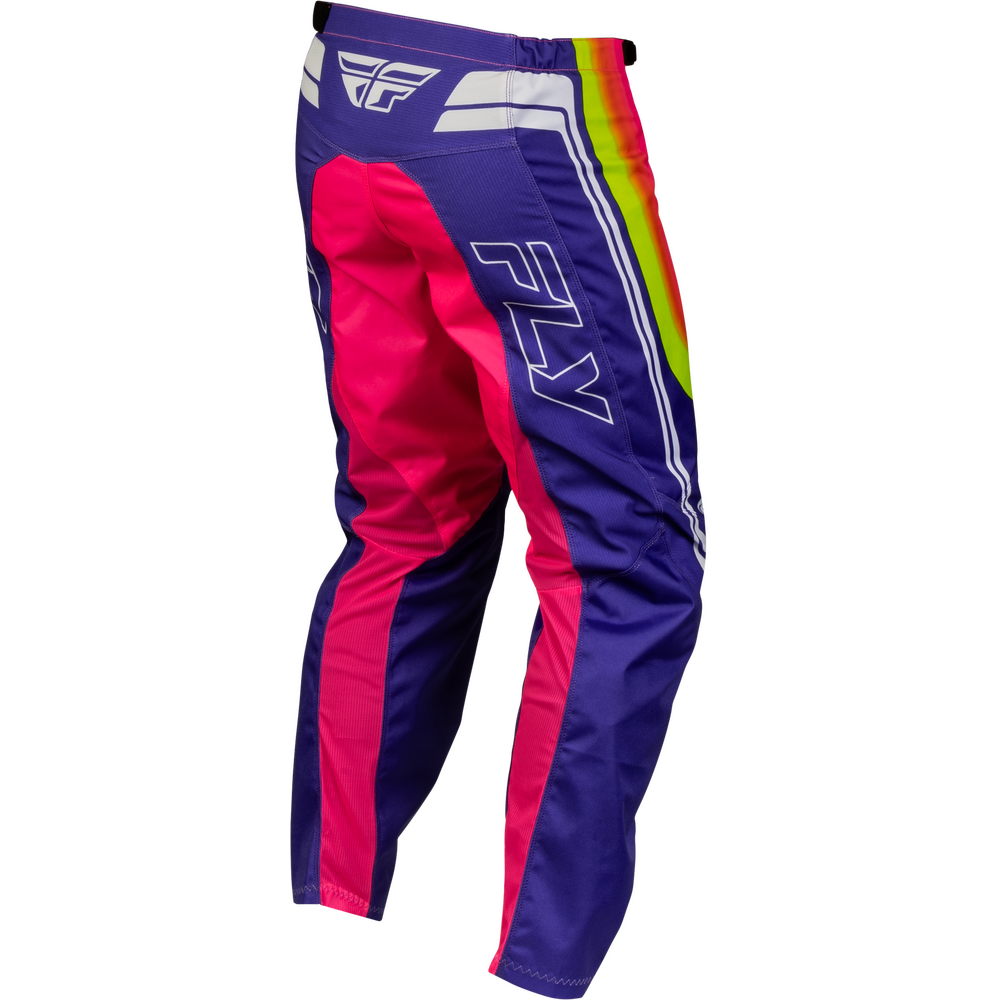 A pair of Fly Racing motocross pants in purple and hot pink, featuring a vibrant rainbow stripe down the side and white branding.