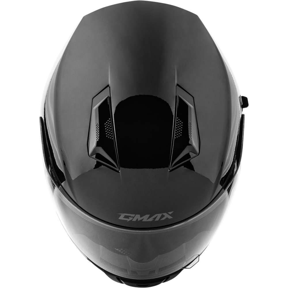 A top-down view of a black full-face motorcycle helmet with the GMAX logo printed on the lower front, set against a plain white background.